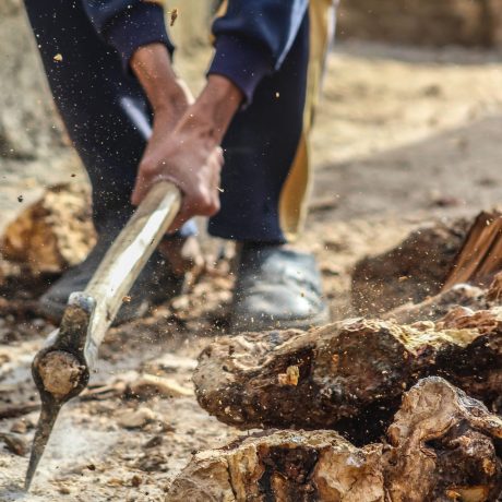person-smashing-pick-axe-on-ground-703157