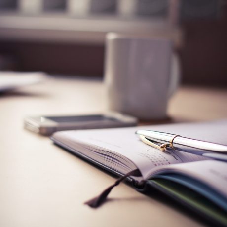 silver-click-pen-on-open-book-210660